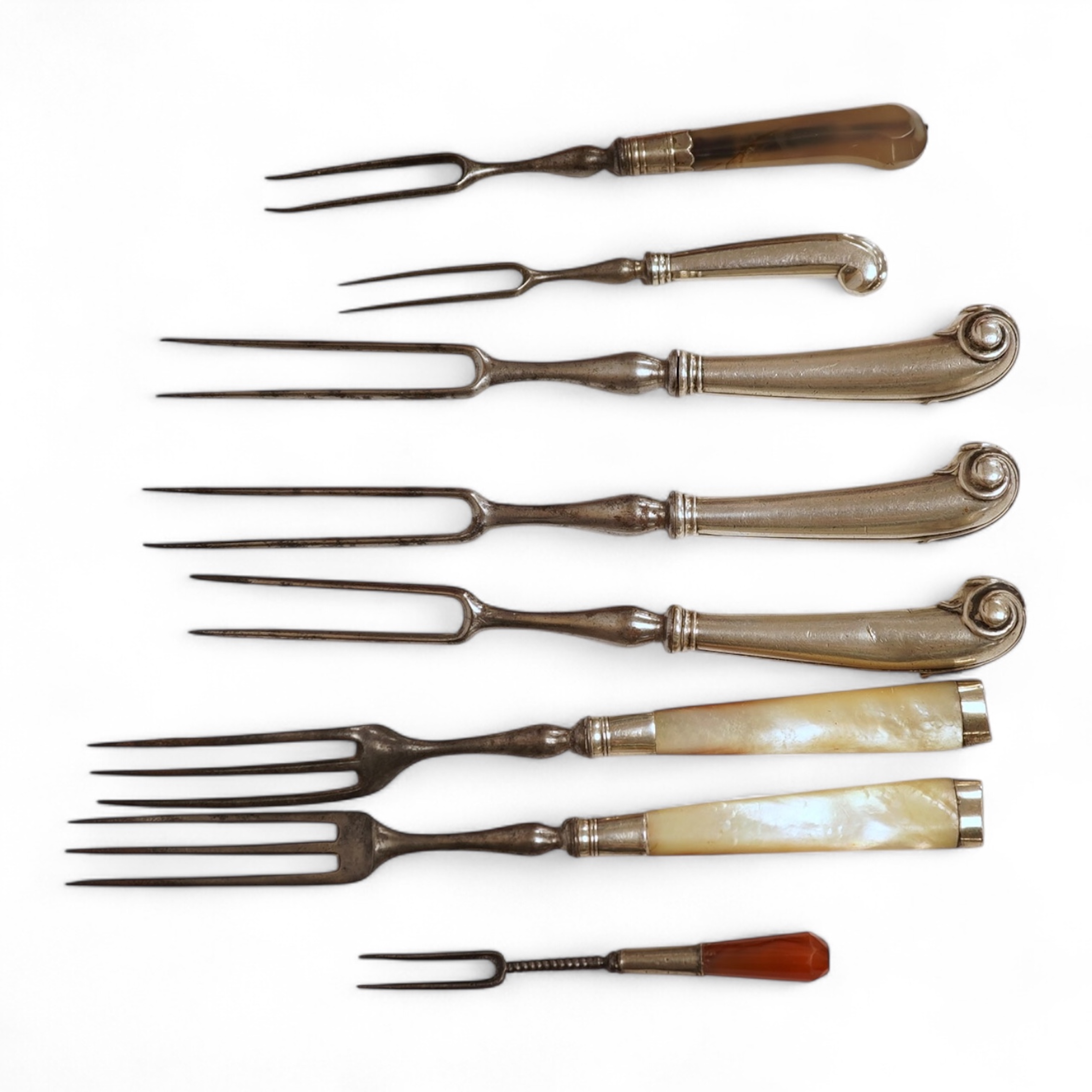 Five assorted George pistol handled steel pronged forks, four with white metal handles and one with agate handle, together with two similar mother of pearl handled steel pronged forks, largest 20.5cm and a small agate ha